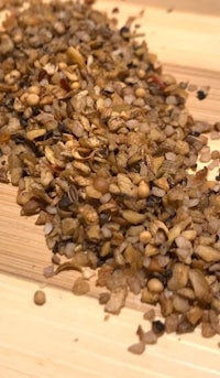a pile of seeds on a wooden surface