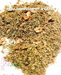 a mixture of herbs and spices on a white plate