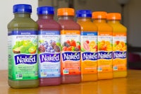 a row of naked juice bottles on a table