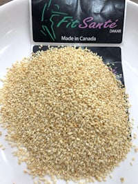 a bowl of sesame seeds with a label on it