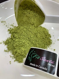 matcha powder in a white bowl with a scoop