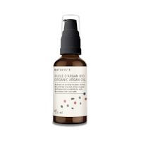 a bottle of rosehip oil on a black background