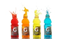 a group of bottles with different colored liquids on a white background