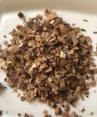 a pile of wood chips on a white plate